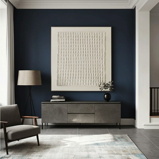 Modern living room with dark blue wall, gray sofa, and decorative items.